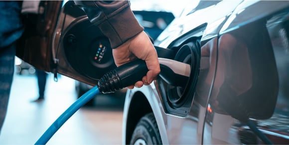 ev-man-shutterstock-charging-electic-vehicle